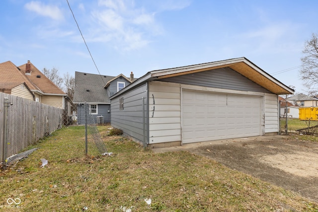 detached garage featuring fence