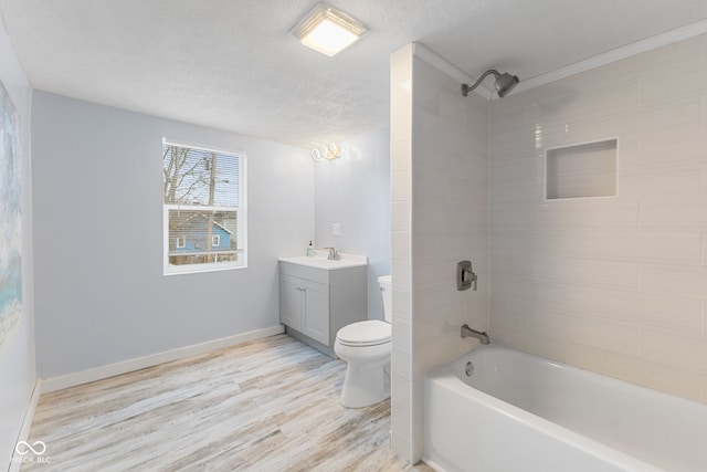 full bathroom featuring vanity, toilet, a textured ceiling, shower / washtub combination, and wood finished floors