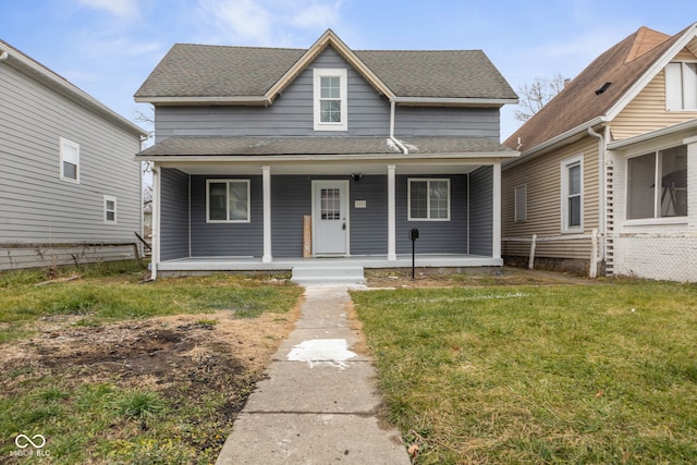 bungalow-style home with a porch, a shingled roof, and a front yard
