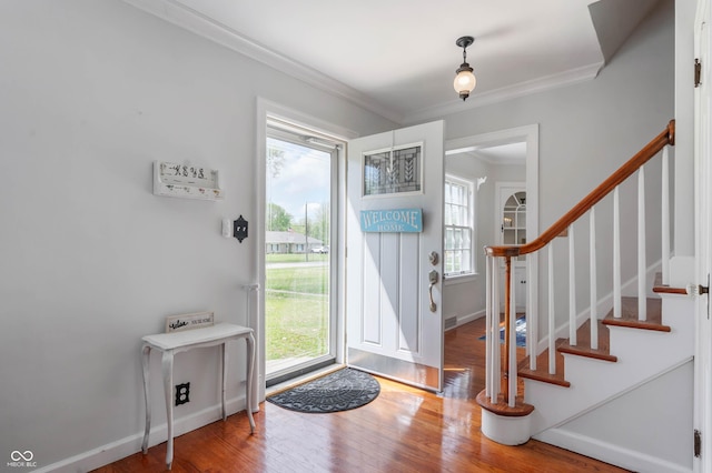 155 N Franklin Rd, Indianapolis, IN 46219 - entryway with crown molding, a wealth of natural light, and wood finished floors