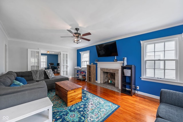 155 N Franklin Rd, Indianapolis, IN 46219 - living room featuring ceiling fan, a fireplace with flush hearth, ornamental molding, and wood finished floors