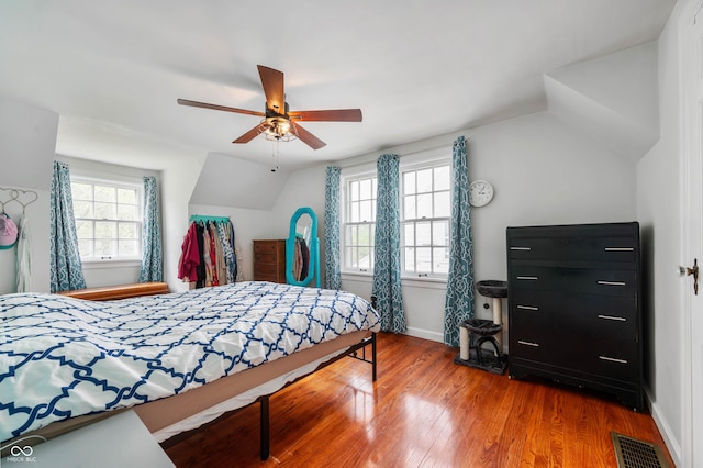 155 N Franklin Rd, Indianapolis, IN 46219 - bedroom with baseboards, vaulted ceiling, wood finished floors, and visible vents