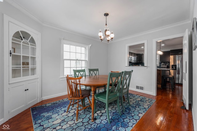 155 N Franklin Rd, Indianapolis, IN 46219 - dining space with crown molding, dark wood finished floors, and an inviting chandelier