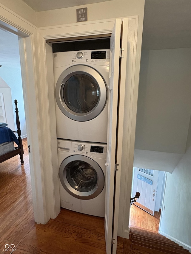 155 N Franklin Rd, Indianapolis, IN 46219 - laundry area featuring wood finished floors, laundry area, and stacked washer / drying machine