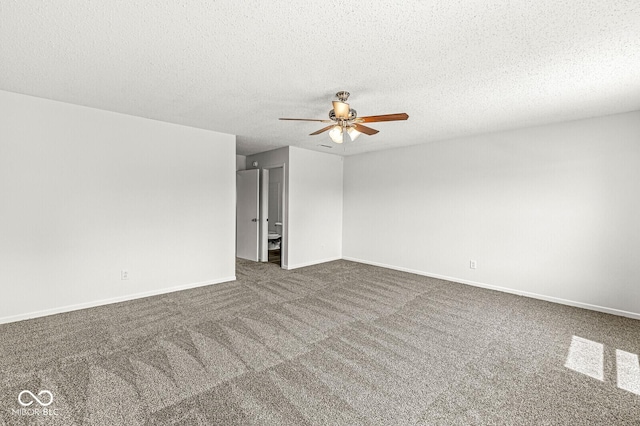 empty room featuring baseboards, carpet flooring, a textured ceiling, and ceiling fan