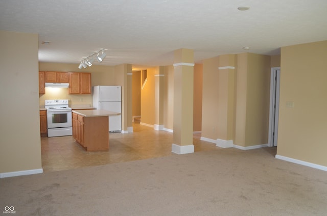 5708 Outer Bank Rd, Indianapolis, IN 46239 - kitchen featuring white appliances, light countertops, light carpet, under cabinet range hood, and a kitchen island