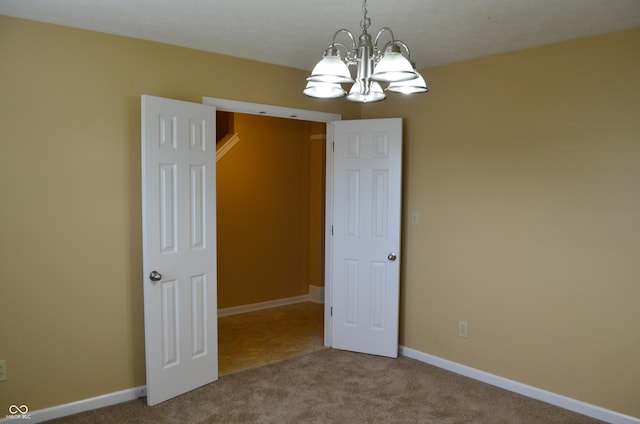 5708 Outer Bank Rd, Indianapolis, IN 46239 - carpeted spare room featuring a chandelier and baseboards