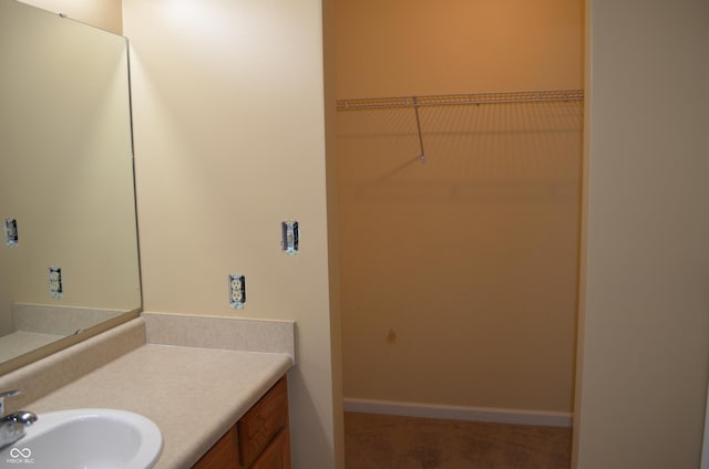 5708 Outer Bank Rd, Indianapolis, IN 46239 - bathroom with vanity and a spacious closet