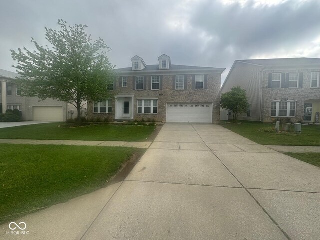 317 Legacy Blvd, Greenwood, IN 46143 - view of front of property with a garage, concrete driveway, brick siding, and a front yard
