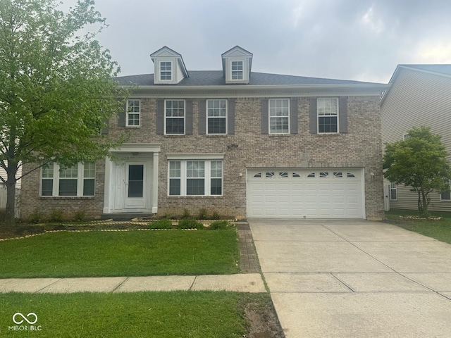 317 Legacy Blvd, Greenwood, IN 46143 - view of front facade with brick siding, a garage, and concrete driveway