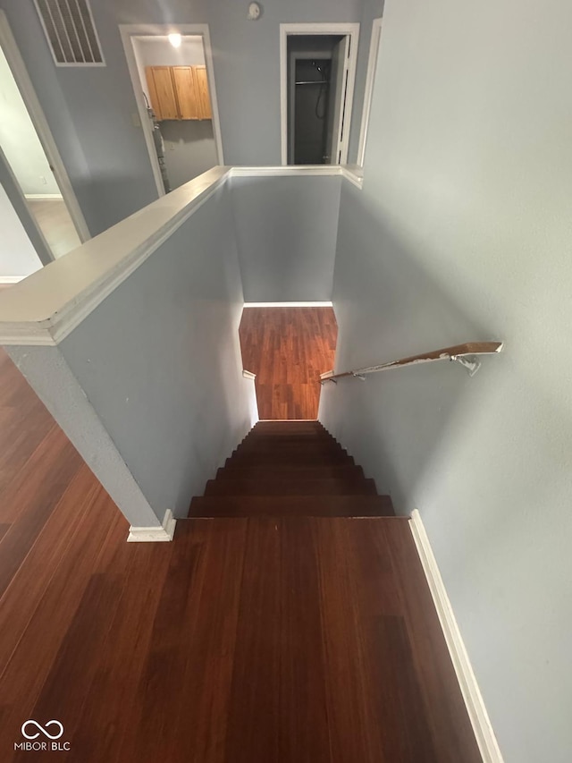 317 Legacy Blvd, Greenwood, IN 46143 - stairs with baseboards, wood finished floors, and visible vents