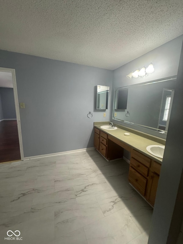 317 Legacy Blvd, Greenwood, IN 46143 - full bathroom featuring double vanity, a textured ceiling, a sink, and marble finish floor
