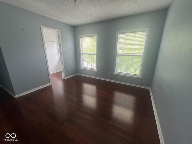 317 Legacy Blvd, Greenwood, IN 46143 - spare room with baseboards, a textured ceiling, and wood finished floors