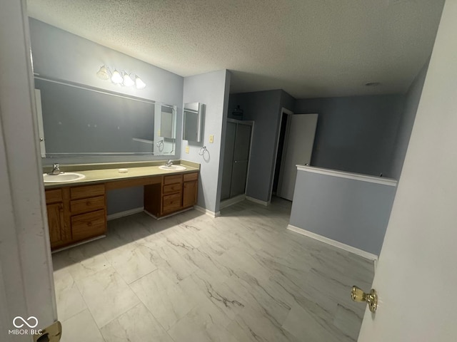 317 Legacy Blvd, Greenwood, IN 46143 - bathroom featuring a sink, a textured ceiling, double vanity, and marble finish floor