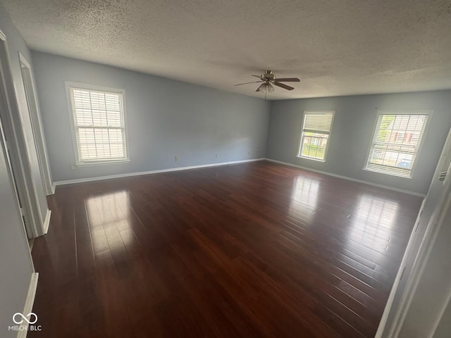 317 Legacy Blvd, Greenwood, IN 46143 - unfurnished room with dark wood-style flooring, a ceiling fan, a textured ceiling, and baseboards