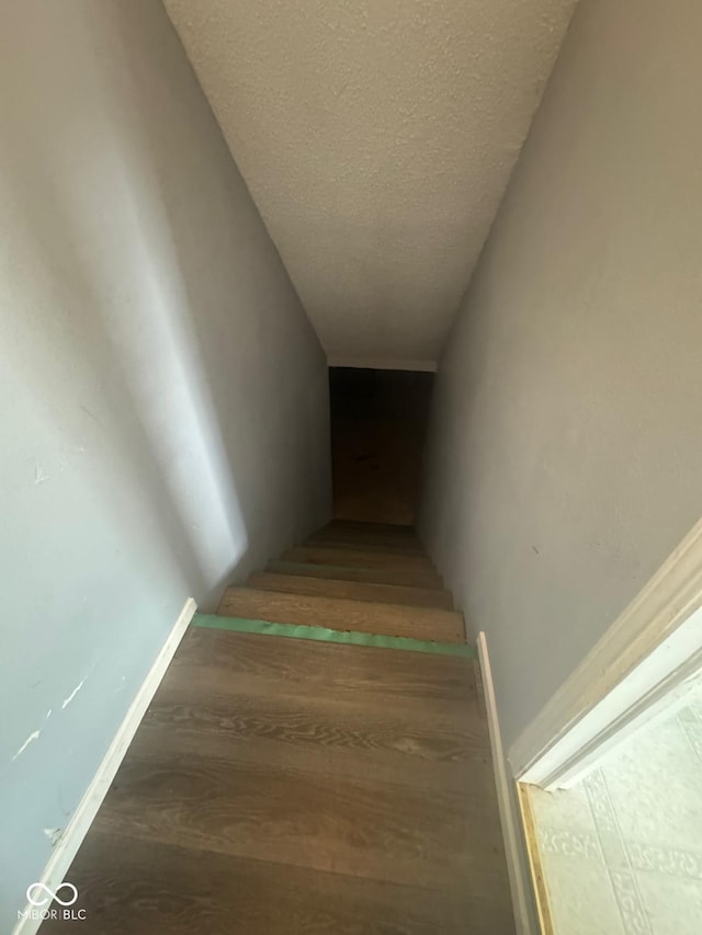317 Legacy Blvd, Greenwood, IN 46143 - staircase featuring a textured ceiling and wood finished floors