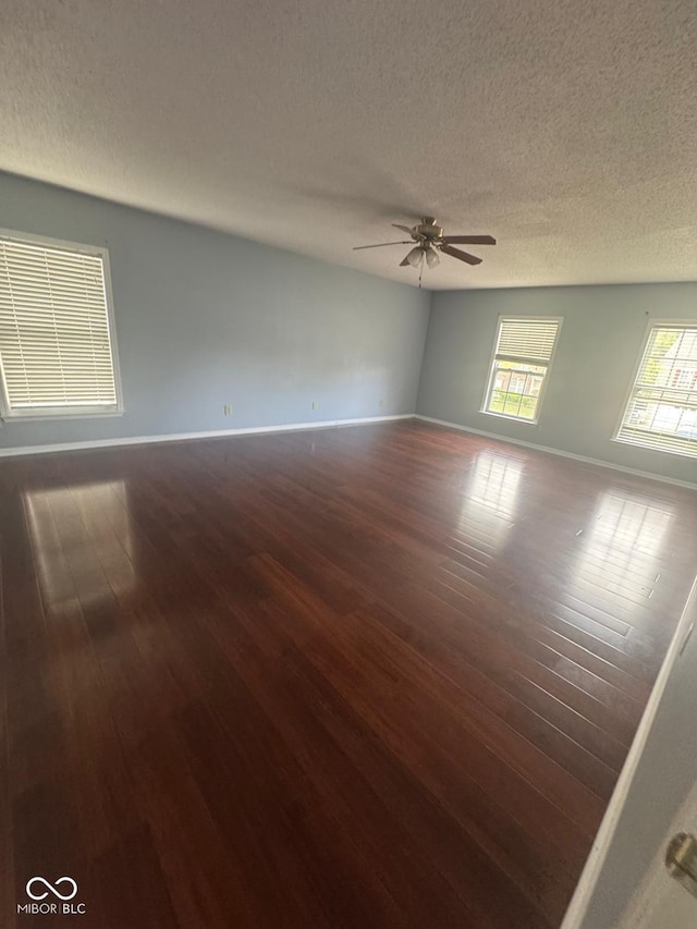 317 Legacy Blvd, Greenwood, IN 46143 - unfurnished room featuring visible vents, baseboards, dark wood-type flooring, a textured ceiling, and a ceiling fan