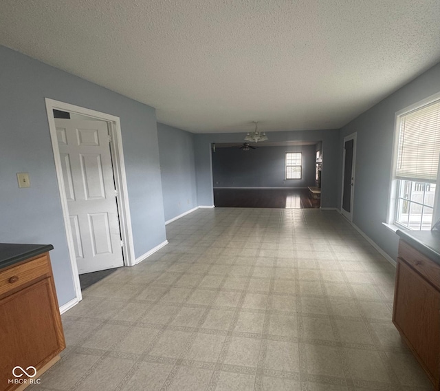 317 Legacy Blvd, Greenwood, IN 46143 - empty room featuring a textured ceiling, a chandelier, and baseboards