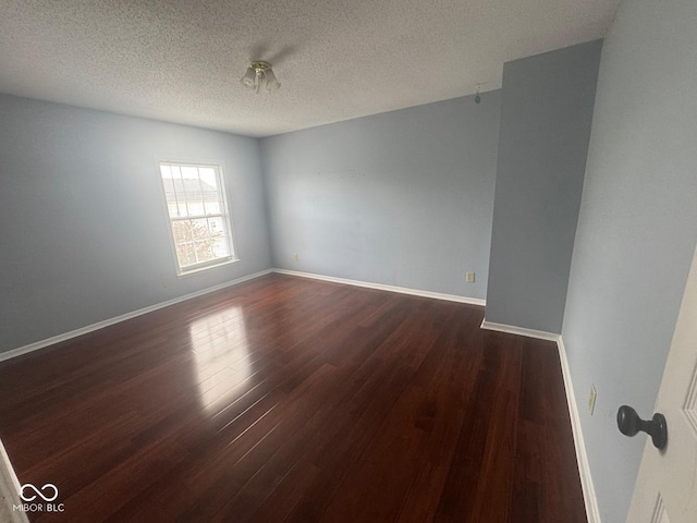 317 Legacy Blvd, Greenwood, IN 46143 - spare room with baseboards, a textured ceiling, and dark wood finished floors