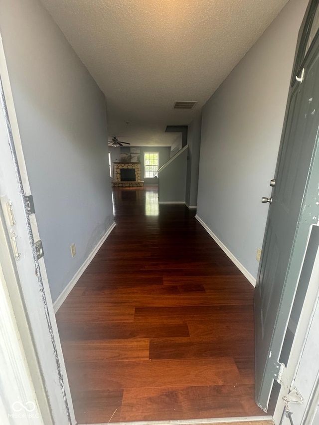 317 Legacy Blvd, Greenwood, IN 46143 - corridor featuring visible vents, baseboards, a textured ceiling, and wood finished floors