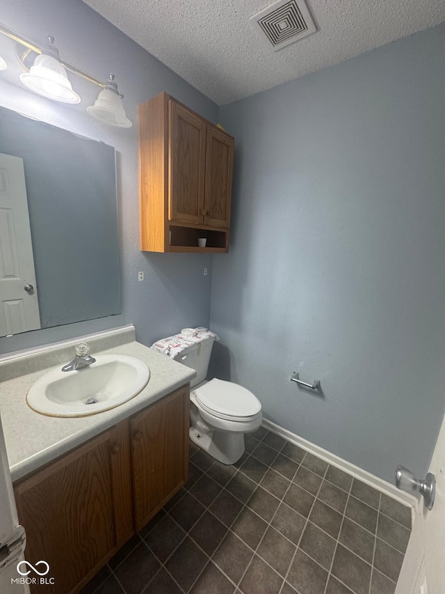 317 Legacy Blvd, Greenwood, IN 46143 - bathroom featuring vanity, toilet, a textured ceiling, tile patterned floors, and visible vents