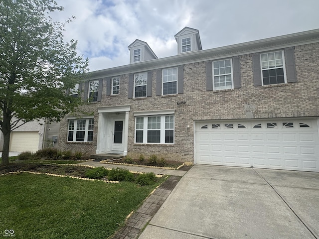 317 Legacy Blvd, Greenwood, IN 46143 - colonial inspired home with brick siding, a garage, a front lawn, and concrete driveway