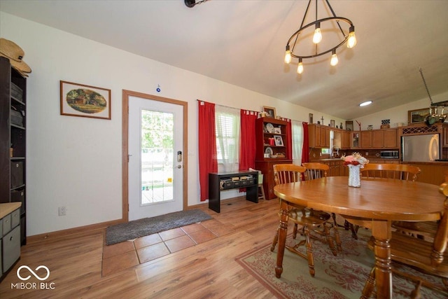 11815 E Pocahontas Dr, Greencastle, IN 46135 - dining room featuring vaulted ceiling, light wood-type flooring, and baseboards