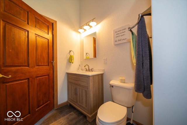 11815 E Pocahontas Dr, Greencastle, IN 46135 - bathroom with vanity, wood finished floors, toilet, and baseboards
