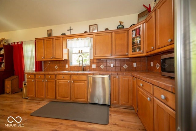 11815 E Pocahontas Dr, Greencastle, IN 46135 - kitchen featuring stainless steel appliances, tile counters, a sink, and brown cabinetry