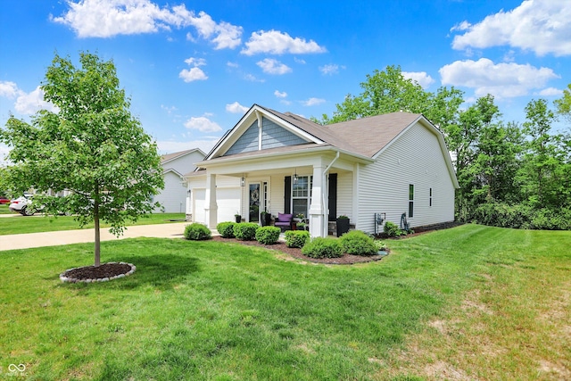 5580 Pintail Ln, Greenwood, IN 46143 - view of front of home featuring a front yard, a garage, covered porch, and driveway