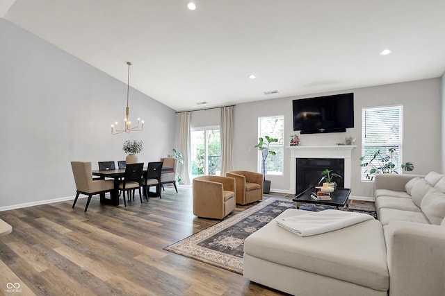 5580 Pintail Ln, Greenwood, IN 46143 - living area featuring recessed lighting, wood finished floors, a chandelier, a glass covered fireplace, and baseboards