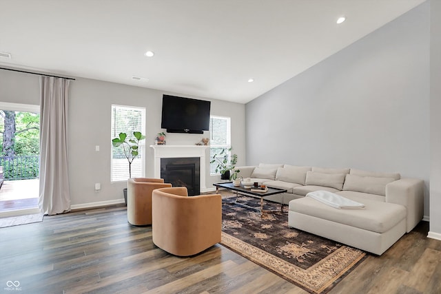 5580 Pintail Ln, Greenwood, IN 46143 - living room with healthy amount of natural light, wood finished floors, recessed lighting, a glass covered fireplace, and lofted ceiling