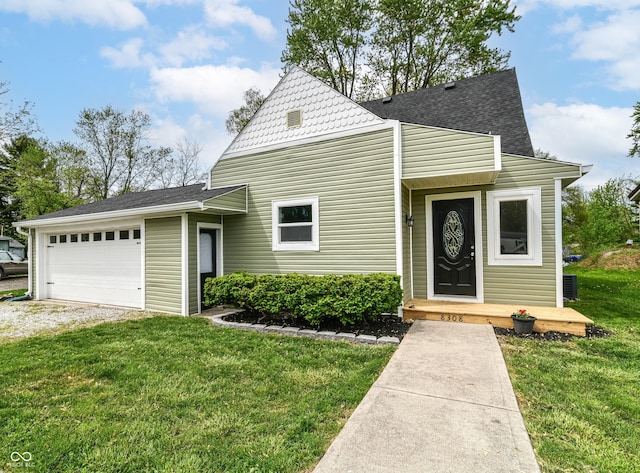 8308 W Main St, Coatesville, IN 46121 - tri-level home with a garage, driveway, a shingled roof, and a front lawn