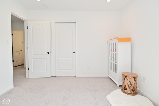 bedroom with recessed lighting, carpet, baseboards, and a closet