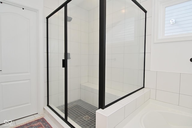 full bath with a stall shower and a bath