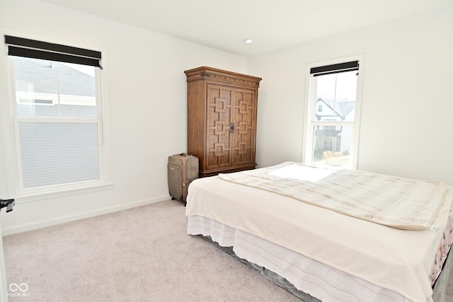 bedroom with baseboards, multiple windows, light carpet, and recessed lighting