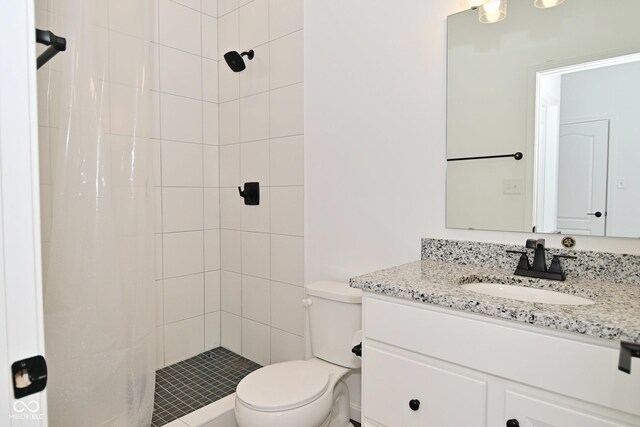full bathroom featuring vanity, a shower stall, and toilet