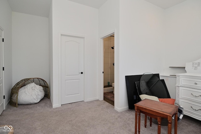 sitting room featuring light colored carpet and baseboards