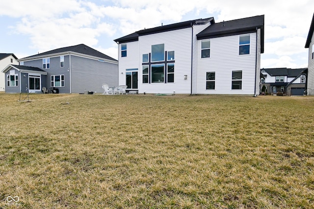 back of house with a lawn