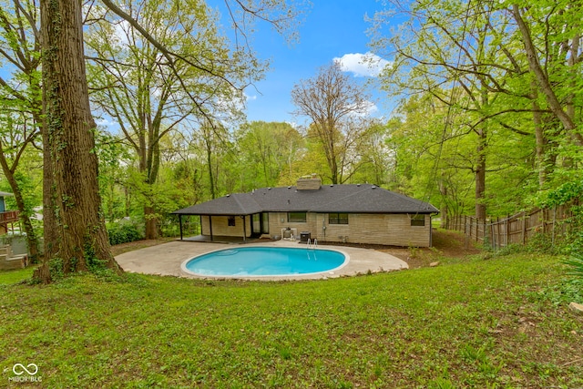 view of swimming pool with a lawn, a patio, fence, and a fenced in pool