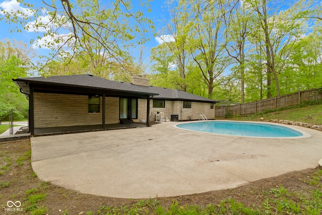 view of pool with a fenced backyard, a fenced in pool, a patio, and central air condition unit