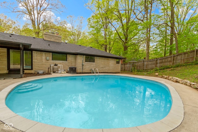 view of swimming pool with a fenced in pool and fence