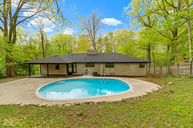 view of swimming pool featuring a fenced in pool, a patio area, and fence