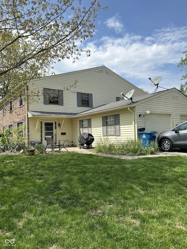 view of front of property featuring a garage and a front yard