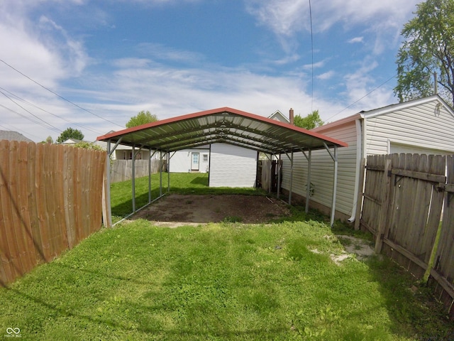 view of yard with a detached carport and driveway