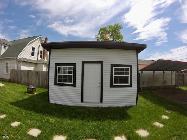 view of outdoor structure featuring a detached carport and an outbuilding