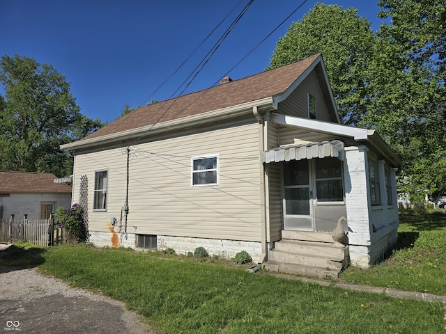 view of property exterior with entry steps and roof with shingles