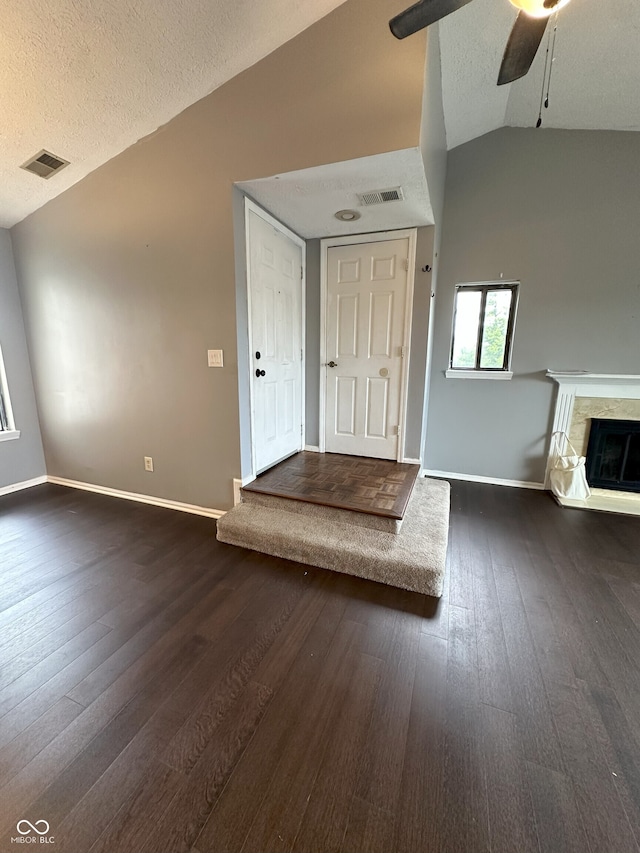 entrance foyer featuring a ceiling fan, baseboards, visible vents, and lofted ceiling