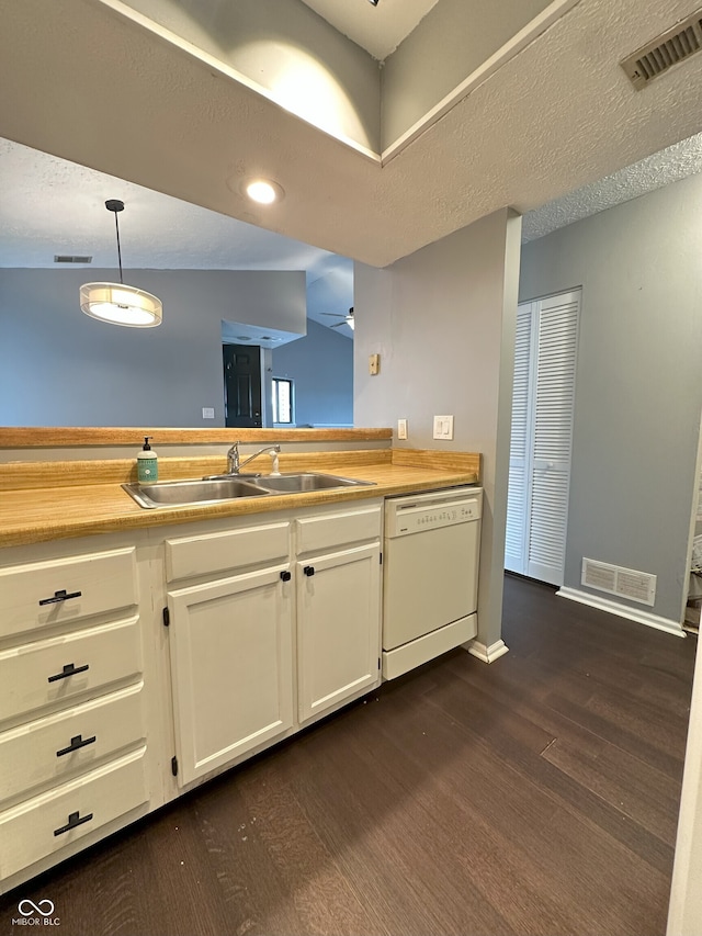 kitchen featuring white cabinetry, visible vents, a sink, and dishwasher