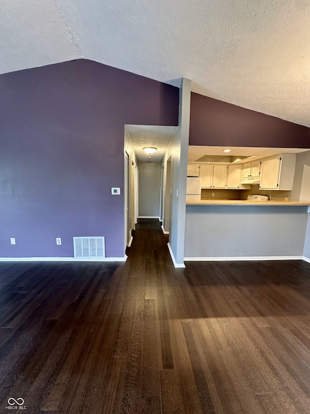 unfurnished living room with baseboards, visible vents, dark wood-style floors, and lofted ceiling